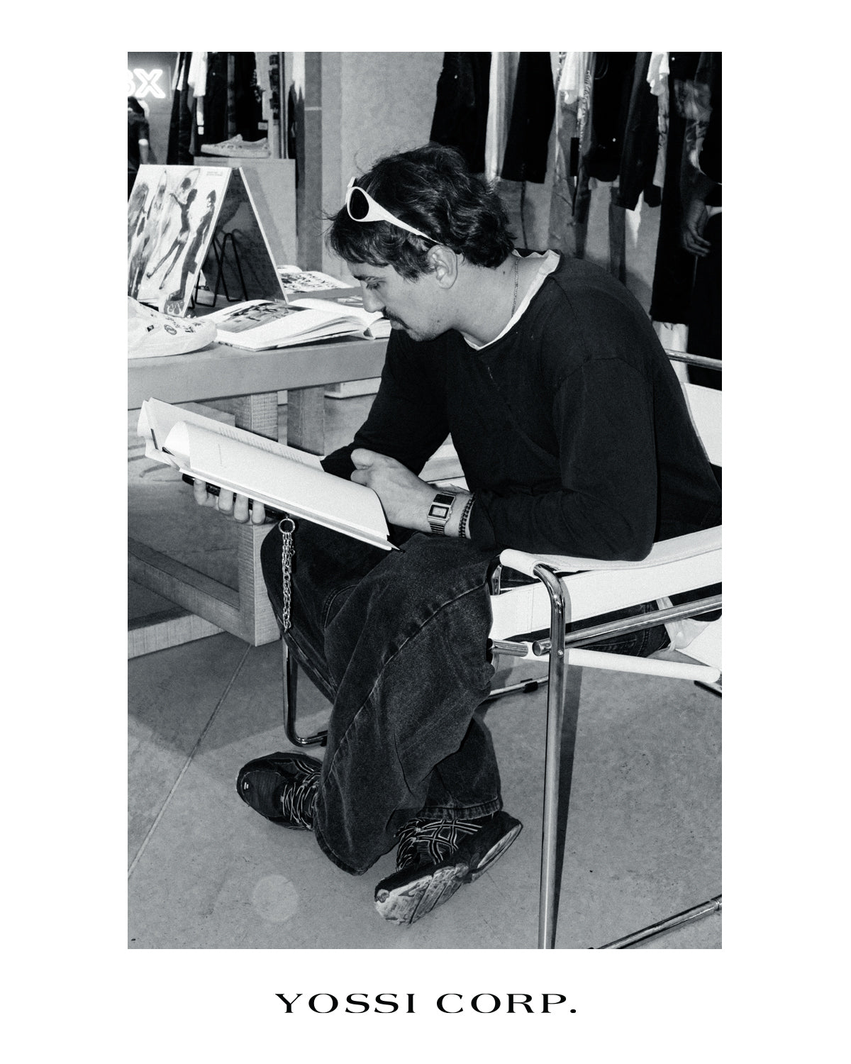 Guest reading an art book, photographed in black and white