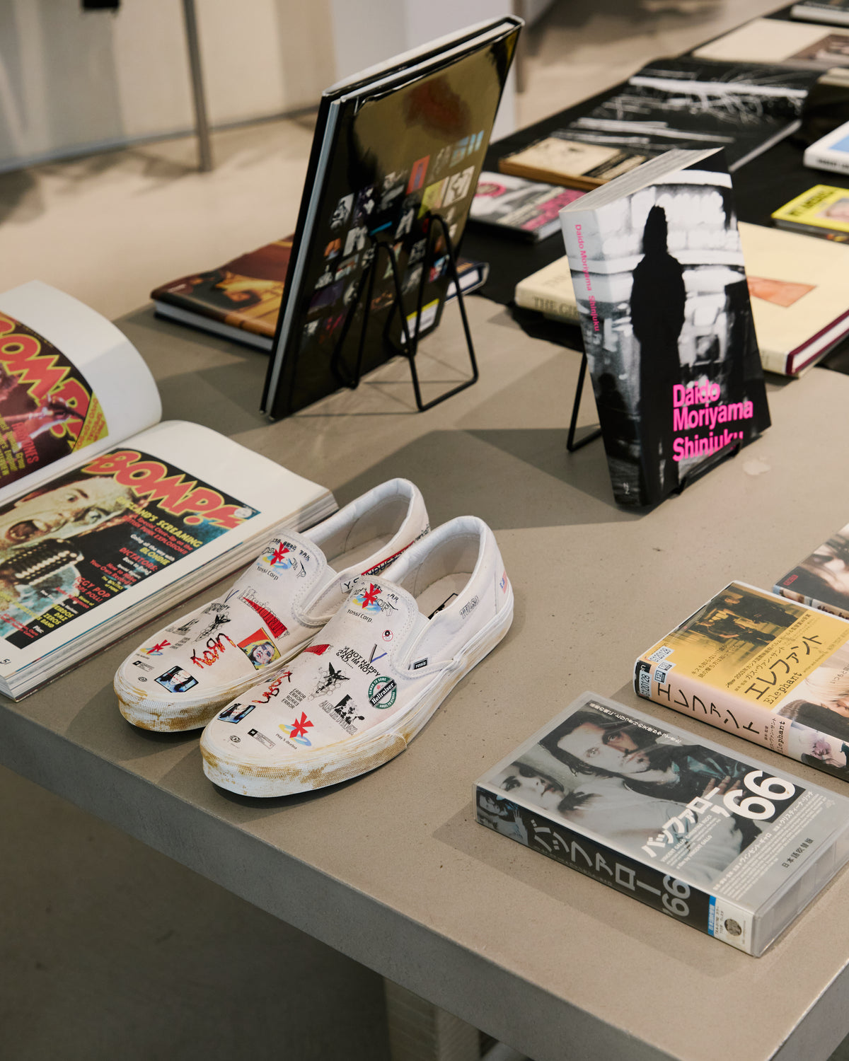 Art books and illustrated shoes on display
