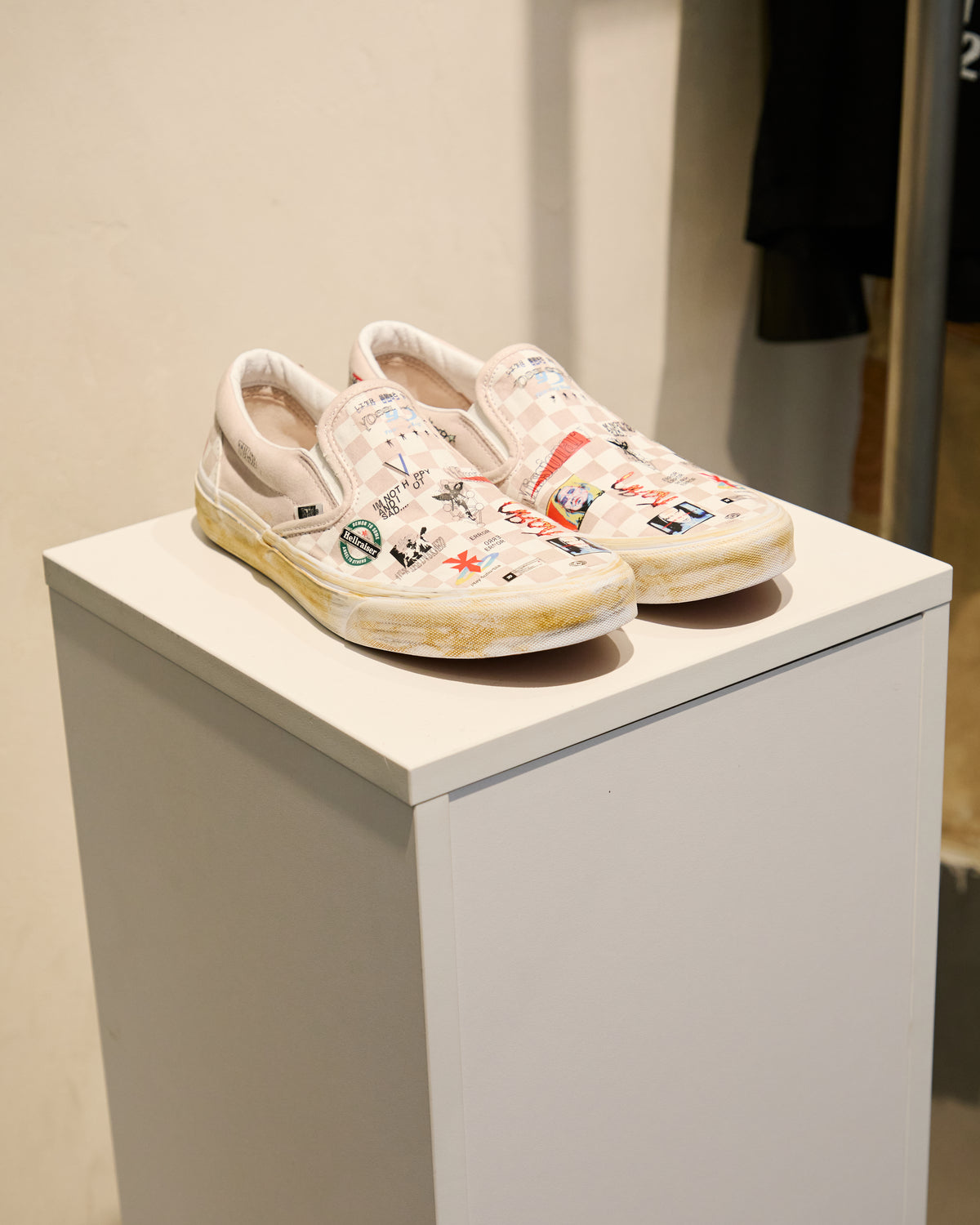 Illustrated shoes displayed on a pedestal