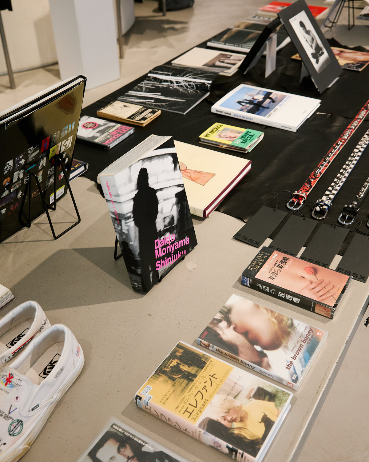 Art books, belts and shoes on the display table