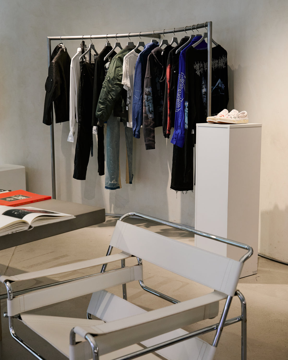 Installation interior with clothing, books and a chair
