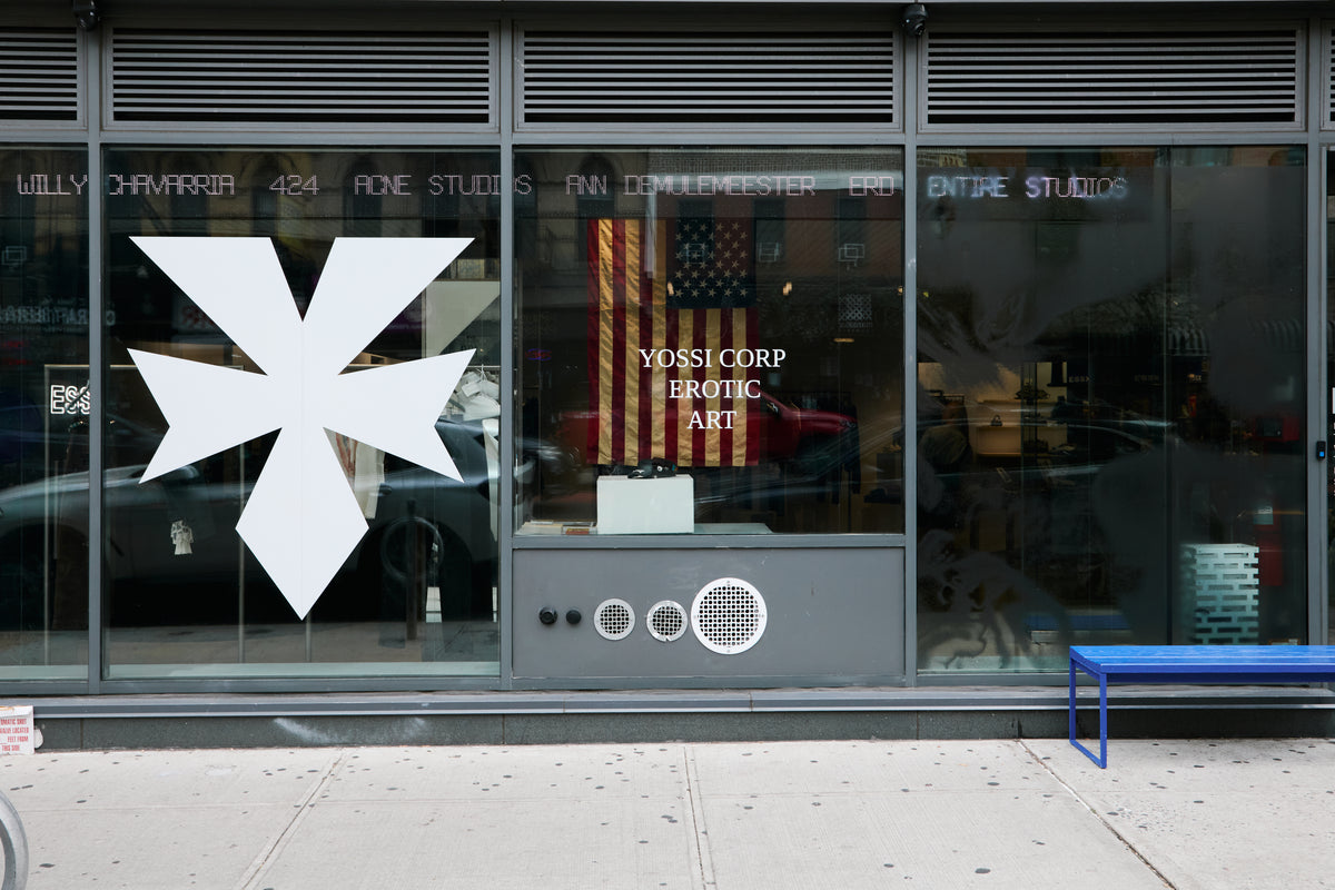 Full storefront window with the YOSSI CORP EROTIC ART installation